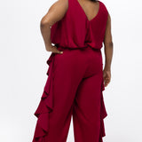Celebrations by Sydney's Closet Style CE2615 in cherry red.

One-piece crepe satin jumpsuit with ruffled on outer pants seams. Bra-friendly straps, blouson bodice and wide leg pants. Center back zipper and scoop neckline. 
