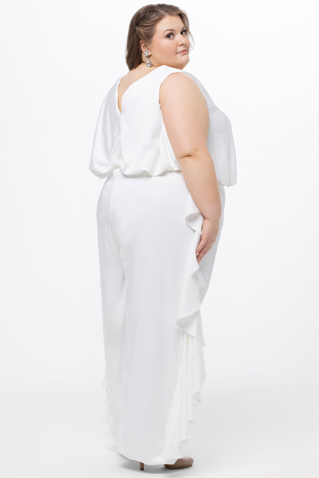 Celebration's by Sydney's Closet style CE2615 in Ivory. 

Crepe satin jumpsuit with a V-neck, bra-friendly straps, wide leg pants and blouson bodice. Ruffle detail on outer seams of pants. V-back with long center back zipper. 