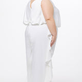 Celebration's by Sydney's Closet style CE2615 in Ivory. 

Crepe satin jumpsuit with a V-neck, bra-friendly straps, wide leg pants and blouson bodice. Ruffle detail on outer seams of pants. V-back with long center back zipper. 