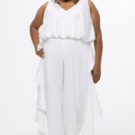 Celebration's by Sydney's Closet style CE2615 in Ivory. 

Crepe satin jumpsuit with a V-neck, bra-friendly straps, wide leg pants and blouson bodice. Ruffle detail on outer seams of pants. V-back with long center back zipper. 