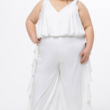 Celebration's by Sydney's Closet style CE2615 in Ivory. 

Crepe satin jumpsuit with a V-neck, bra-friendly straps, wide leg pants and blouson bodice. Ruffle detail on outer seams of pants. V-back with long center back zipper. 