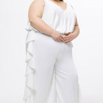 Celebration's by Sydney's Closet style CE2615 in Ivory. 

Crepe satin jumpsuit with a V-neck, bra-friendly straps, wide leg pants and blouson bodice. Ruffle detail on outer seams of pants. V-back with long center back zipper. 