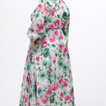 Celebration's by Sydney's Closet style CE2621 in floral. 

Button down plus size ankle length floral gown made from printed organza. V-neck, long pouf sleeves with cuff and optional belt. A-line skirt with pockets.