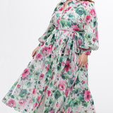 Celebration's by Sydney's Closet style CE2621 in floral. 

Button down plus size ankle length floral gown made from printed organza. V-neck, long pouf sleeves with cuff and optional belt. A-line skirt with pockets.