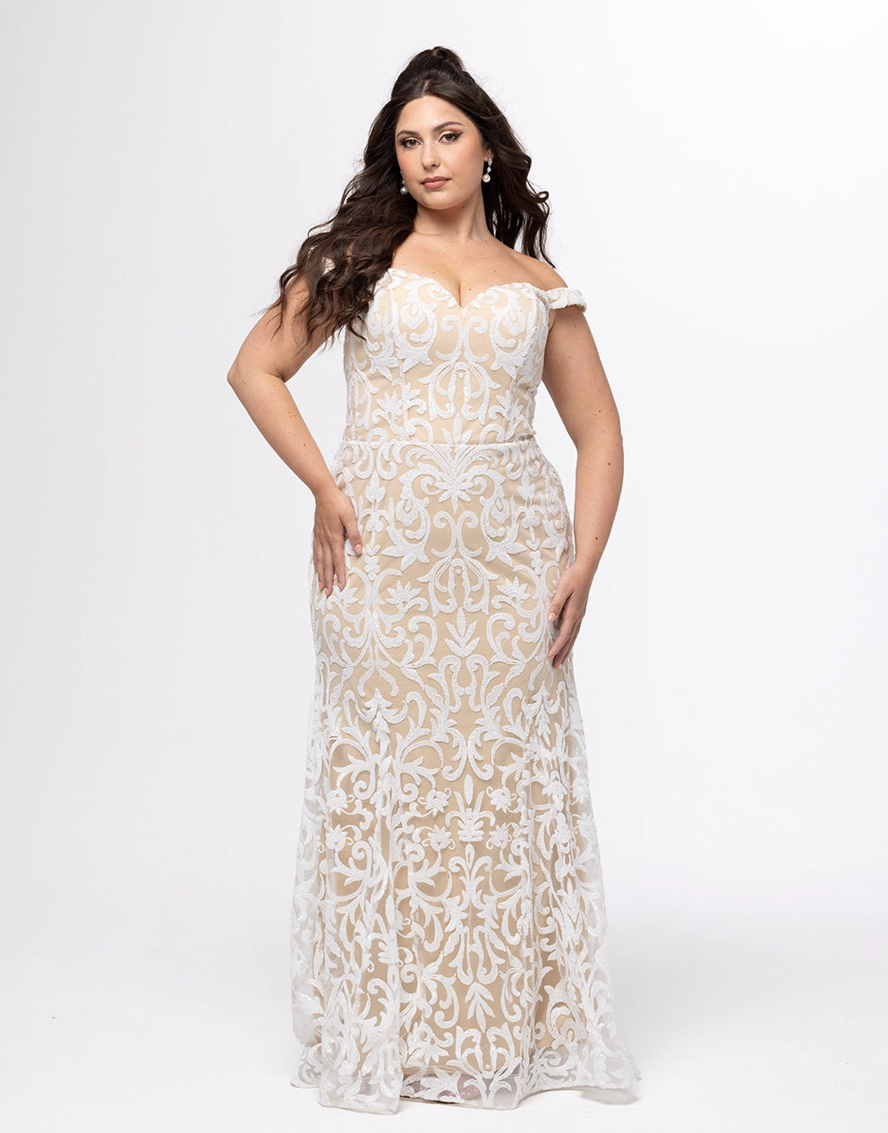 Woman wearing a white and nude carriage patterned dress on a white background