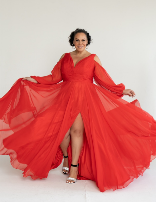 Woman wearing a flowing red dress on a white background