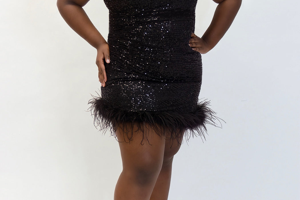 This is JK2401 in our collection Johnathan Kayne for Sydney's Closet. This plus size party dress comes in blue, red, black and white. This dress is one shoulder, all over sequins, an asymmetrical skirt, and has a feather hem.