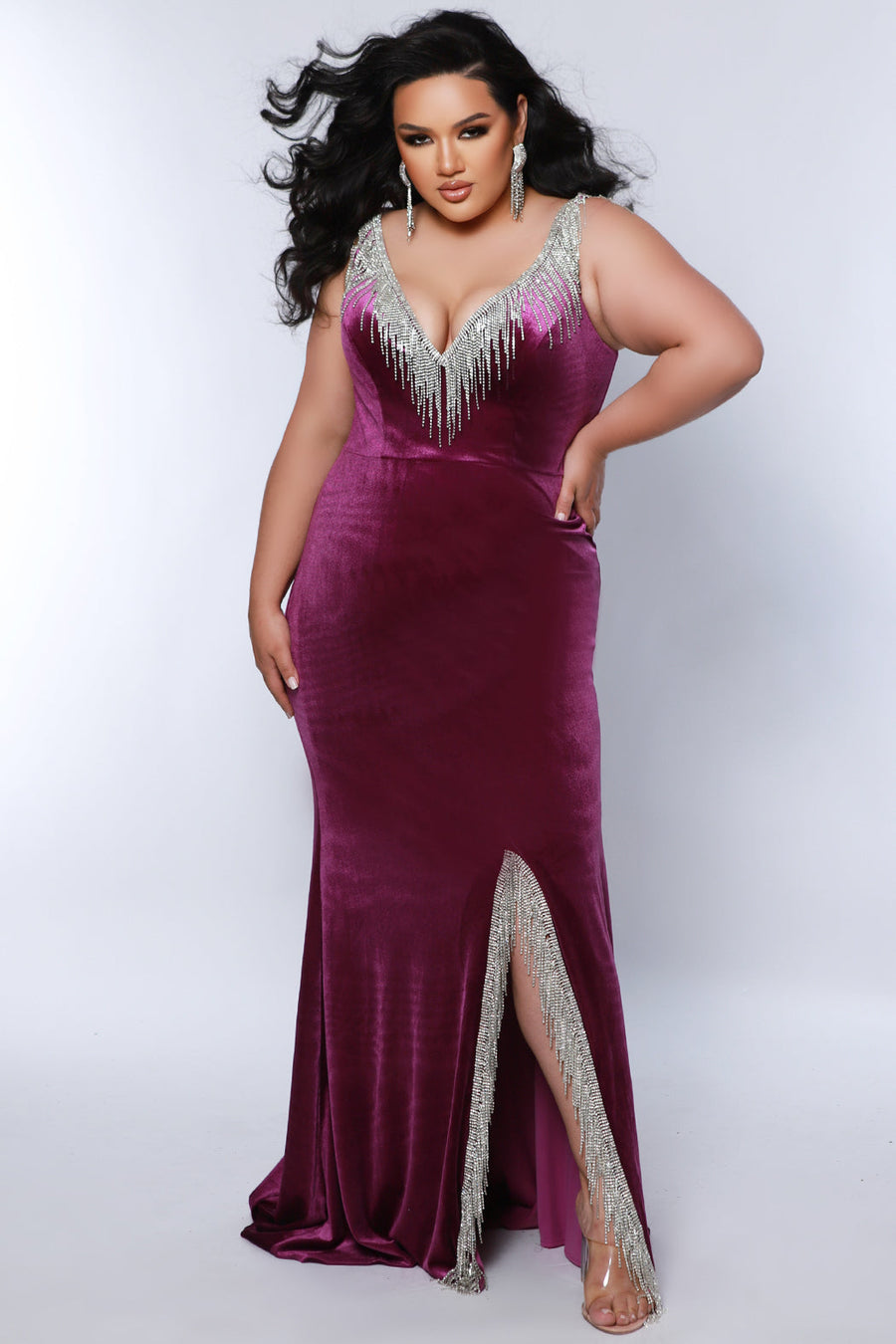 Johnathan Kayne for Sydney's Closet JK2412 Purple. Slim/Fitted silhouette, Deep V-neckline, Bra-friendly straps, Silver beaded trim and fringe on neckline, straps, and back, Natural waistline, Slim skirt with center slit.