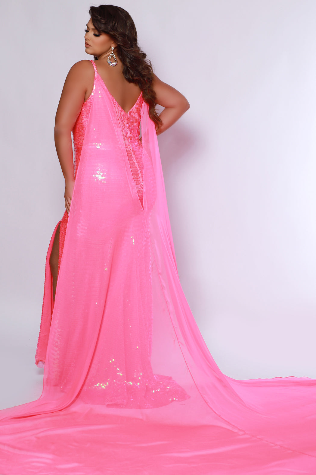 Johnathan Kayne for Sydney's Closet JK2413 Flamingo. Princess line silhouette, Slim fit, Piano sequins, V-back, Center back zipper, Deep V-neckline, Nude mesh insert, Spaghetti straps covered in piano sequins, Detachable chiffon cape = 105 inches from shoulder to hem, Piano sequins, High slit, Sweep train with godet.