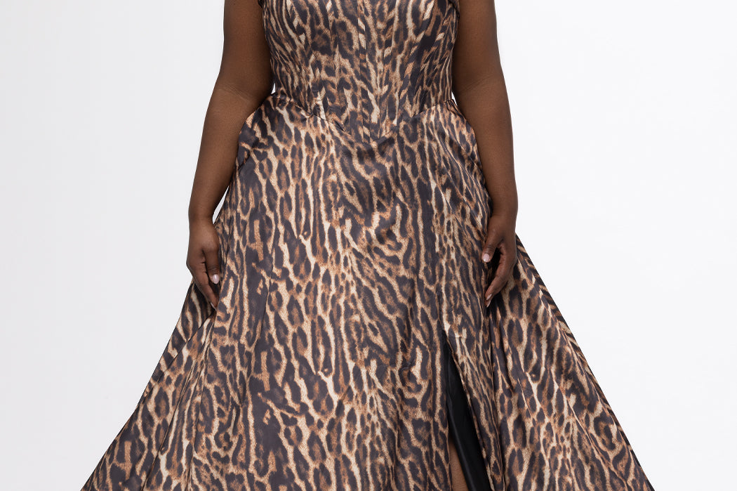 Johnathan Kayne for Sydney's Closet style JK2605. 

Plus size floor length animal print dress.  Fold over cuff detail, exposed corset boning, natural waistline, and A-line skirt with pockets and center back zipper. Available in sizes 14-32 in animal print. 