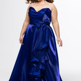 Johnathan Kayne for Sydney's Closet style JK2608.

Strapless sweetheart plus size A-line gown.  Ruched bodice with bow at natural waistline and flounce down left leg slit. Shiny organza fabric for lightweight comfort. Available in sizes  10-32 in Red, Black and Blue. 