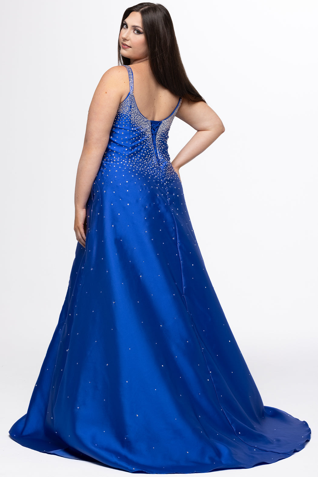 Johnathan Kayne for Sydney's Closet style JK2613. 

Plus size A-line gown with hot fix stones on thick satin fabric. Heavily embellished deep V-neckline with nude-mesh insert and embellished one inch straps. A-line skirt with left leg slit. Lace up back with modesty panel and half zipper. Available in sizes 10-32 in red, blue and black. 
