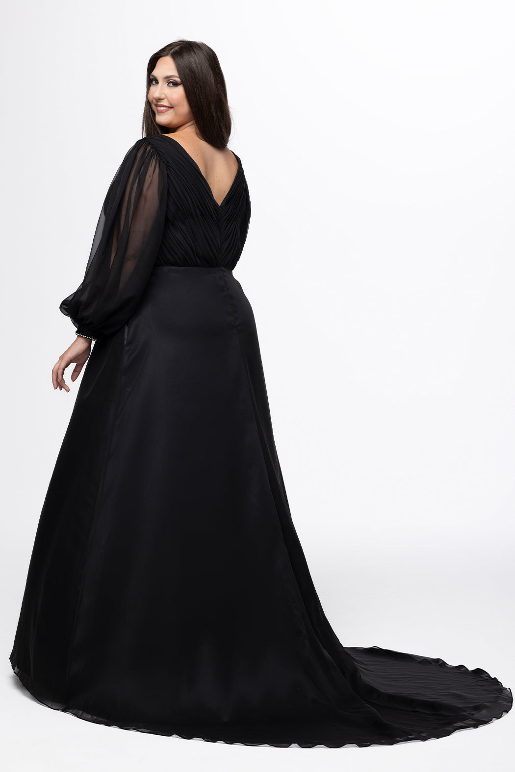 Johnathan Kayne for Sydney's Closet style JK2614. 

Plus size A-line chiffon gown with long bishop sleeves, beaded cuff and bicep slit. Bra-friendly straps, v-neckline and pleated bodice. Natural waistline with 4 inch beaded, rhinestone and sequin embellished waistband. Pockets, left leg slit with zipper, v-back and center back zipper. Available in sizes 10-32 in black, blue and red. 