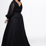 Johnathan Kayne for Sydney's Closet style JK2614. 

Plus size A-line chiffon gown with long bishop sleeves, beaded cuff and bicep slit. Bra-friendly straps, v-neckline and pleated bodice. Natural waistline with 4 inch beaded, rhinestone and sequin embellished waistband. Pockets, left leg slit with zipper, v-back and center back zipper. Available in sizes 10-32 in black, blue and red. 