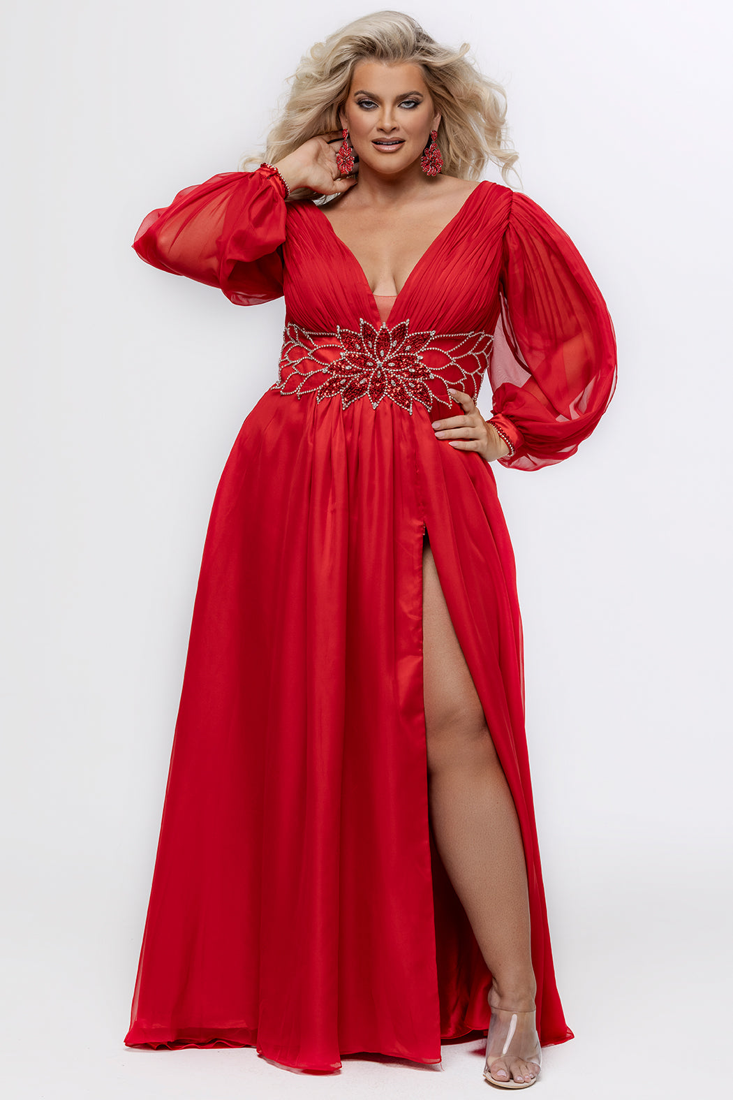 Johnathan Kayne for Sydney's Closet style JK2614. 

Plus size A-line chiffon gown with long bishop sleeves, beaded cuff and bicep slit. Bra-friendly straps, v-neckline and pleated bodice. Natural waistline with 4 inch beaded, rhinestone and sequin embellished waistband. Pockets, left leg slit with zipper, v-back and center back zipper. Available in sizes 10-32 in black, blue and red. 