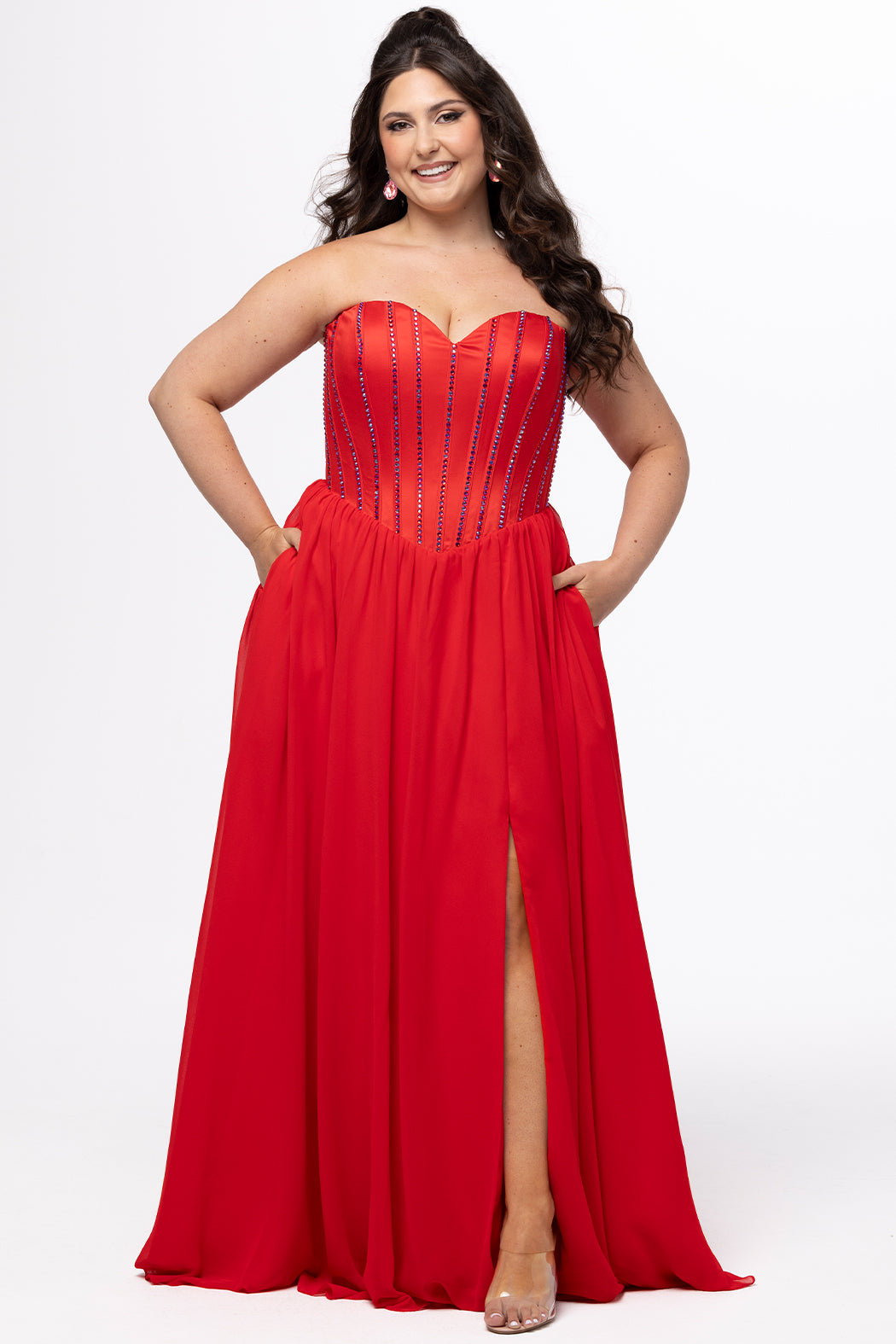 Johnathan Kayne for Sydney's Closet style JK2616. 

Strapless sweetheart plus size evening gown. Exposed bones covered in hot fix stones. Basque waist, chiffon A-line skirt, pockets, and left leg slit. Center back zipper. Available in sizes 10-32 in blue, black and red. 