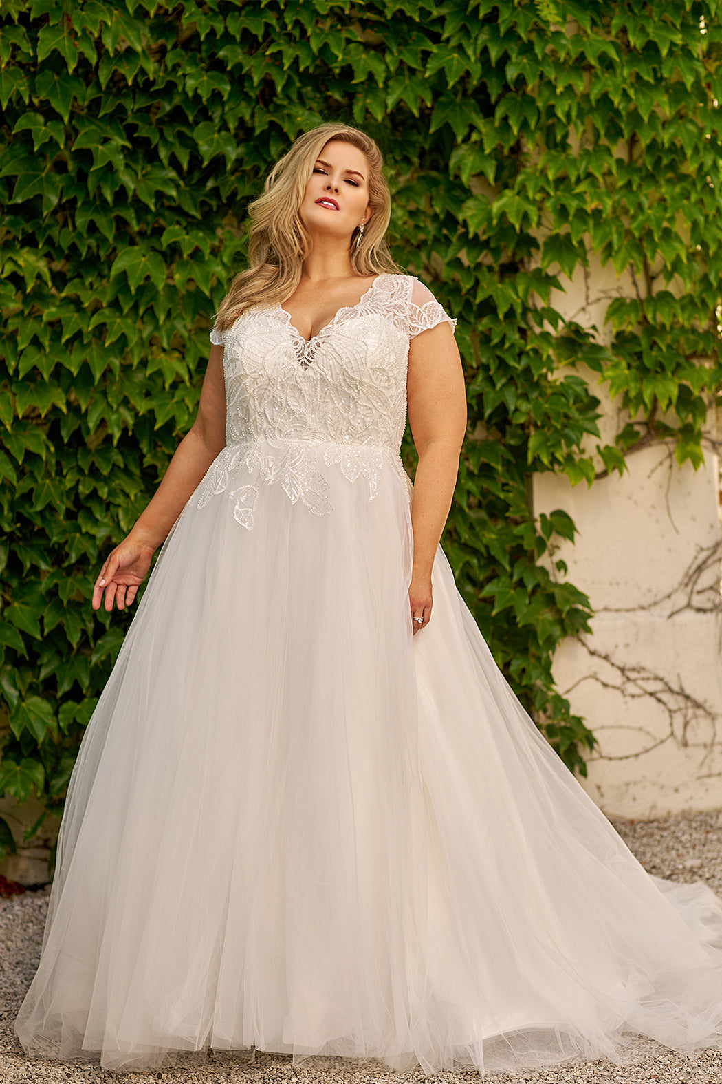 Michelle Bridal style MB2309 plus size bridal gown with modern lace appliques, hand beading, cap sleeve and long tulle skirt. Available in black or ivory. Only sold in stores.