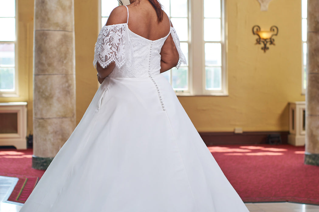 Michelle Bridal 2406. Lace and bridal satin, A-line silhouette, V-neckline, Spaghetti straps, Optional drop lace sleeves, V-back with invisible zipper covered in 30 buttons. Natural waistline, Aline skirt with slit starting 15 inches below waist, Pockets on each side seam