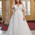 Michelle Bridal MB2408 Ivory. Bridal tulle and satin with leaf and floral appliques, Ballgown silhouette, V-neckline, Spaghetti straps covered in appliques, Drape sleeve, Invisible center back zipper with 24 covered buttons and elastic loops, Natural waistline, Scoop back