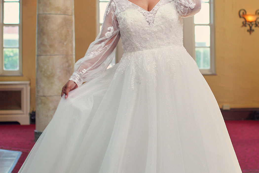 Michelle Bridal MB2415 Ivory. Soft bridal tulle over sparkle tulle over soft bridal tulle over tulle, A-line, V-neckline, Bodice is illusion mesh covered in appliques, long sleeve covered with appliques, Natural waistline, Long invisible center back zipper.