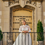 Michelle Bridal MB2424 Ivory. Embroidered lace appliques on mesh, Bridal tulle, sparkle tulle, Light lining, Leaf lace appliques, clear sequins, cut glass, Ballgown silhouette, High Neckline, Collar = 1 inch beaded appliques, Illusion bodice covered in beaded appliques, Sweetheart lining, Long sleeves covered in appliques with sequins, Closure at wrist = covered buttons with elastic loops, V-back, Invisible center back zipper.