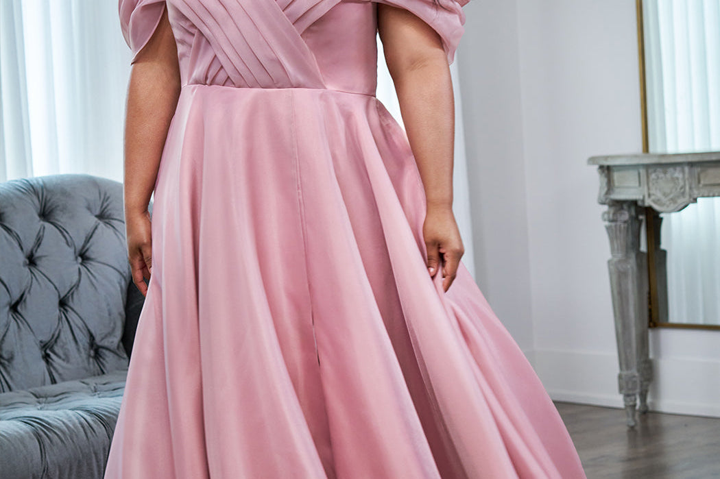 Michelle Bridal MB2506 plus size wedding dress by Sydney's Closet. Off-the-shoulder pleated straps, organza ballgown with slit and long train available in black, ivory or mauve pink