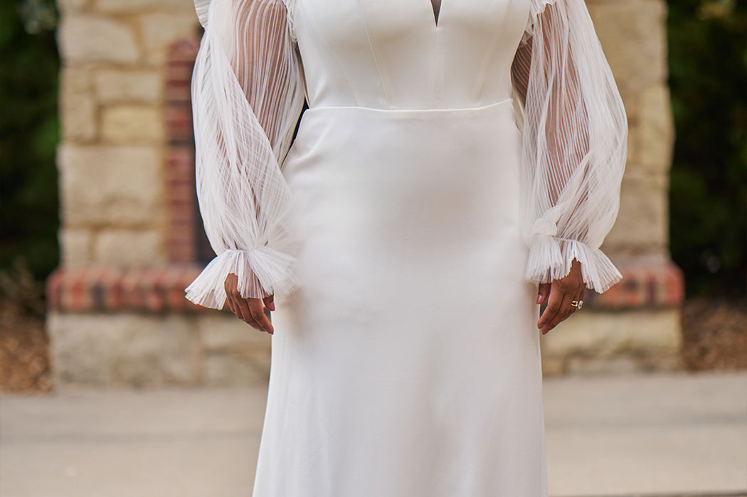 Sophisticated and sexy plus size simple crepe wedding dress with detachable puff sleeves.  Plain crepe slim front with sweetheart neckline and natural waist.  Optional lining included for the back bodice with criss-cross exposed boning.  Michelle Bridal by Sydney's Closet style MB2522