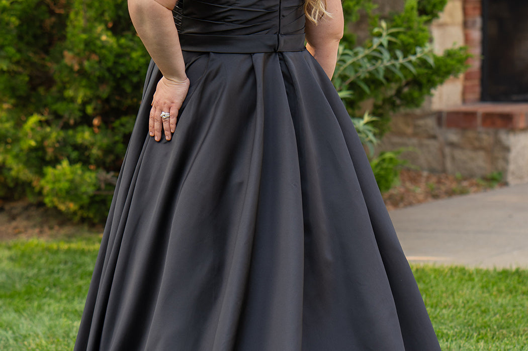 Strapless satin plus size wedding gown with pleated bodice and detachable belt included. A-line skirt with box pleats, pockets and long train. Michelle Bridal style MB2523 is available in ivory or black. 