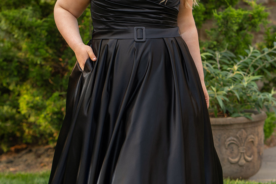 Strapless satin plus size wedding gown with pleated bodice and detachable belt included. A-line skirt with box pleats, pockets and long train. Michelle Bridal style MB2523 is available in ivory or black. 