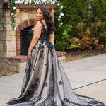 Plus size A-line oversized floral weding dress in black, ivory or champagne. Style MB2525 from Michelle Bridal by Sydney's Closet has illusions straps covered in appliques, natural waisltine, long flowy A-line skirt and long train with covered buttons. 
