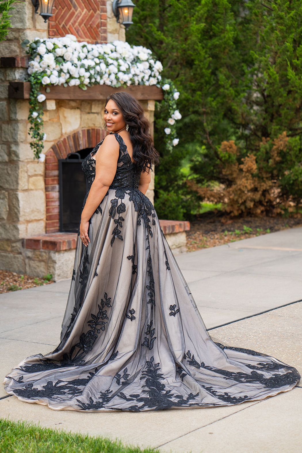 Plus size A-line oversized floral weding dress in black, ivory or champagne. Style MB2525 from Michelle Bridal by Sydney's Closet has illusions straps covered in appliques, natural waisltine, long flowy A-line skirt and long train with covered buttons. 