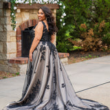 Plus size A-line oversized floral weding dress in black, ivory or champagne. Style MB2525 from Michelle Bridal by Sydney's Closet has illusions straps covered in appliques, natural waisltine, long flowy A-line skirt and long train with covered buttons. 