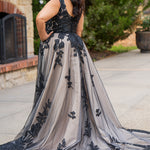 Plus size A-line oversized floral weding dress in black, ivory or champagne. Style MB2525 from Michelle Bridal by Sydney's Closet has illusions straps covered in appliques, natural waisltine, long flowy A-line skirt and long train with covered buttons. 
