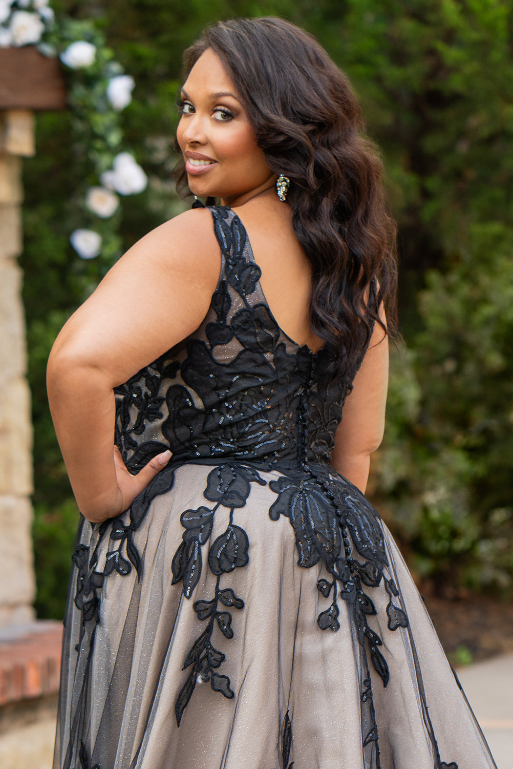 Plus size A-line oversized floral weding dress in black, ivory or champagne. Style MB2525 from Michelle Bridal by Sydney's Closet has illusions straps covered in appliques, natural waisltine, long flowy A-line skirt and long train with covered buttons. 