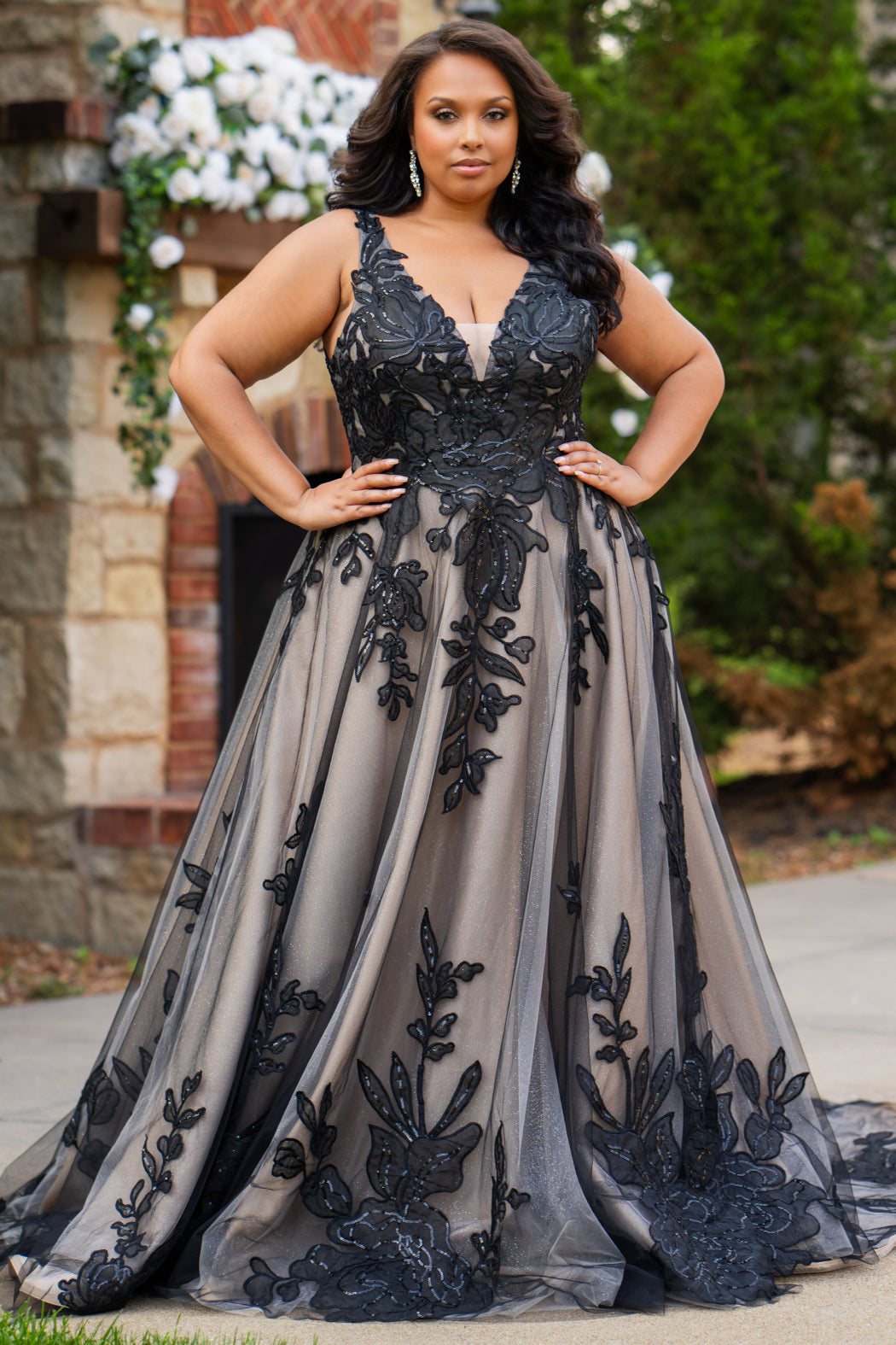 Plus size A-line oversized floral weding dress in black, ivory or champagne. Style MB2525 from Michelle Bridal by Sydney's Closet has illusions straps covered in appliques, natural waisltine, long flowy A-line skirt and long train with covered buttons. 