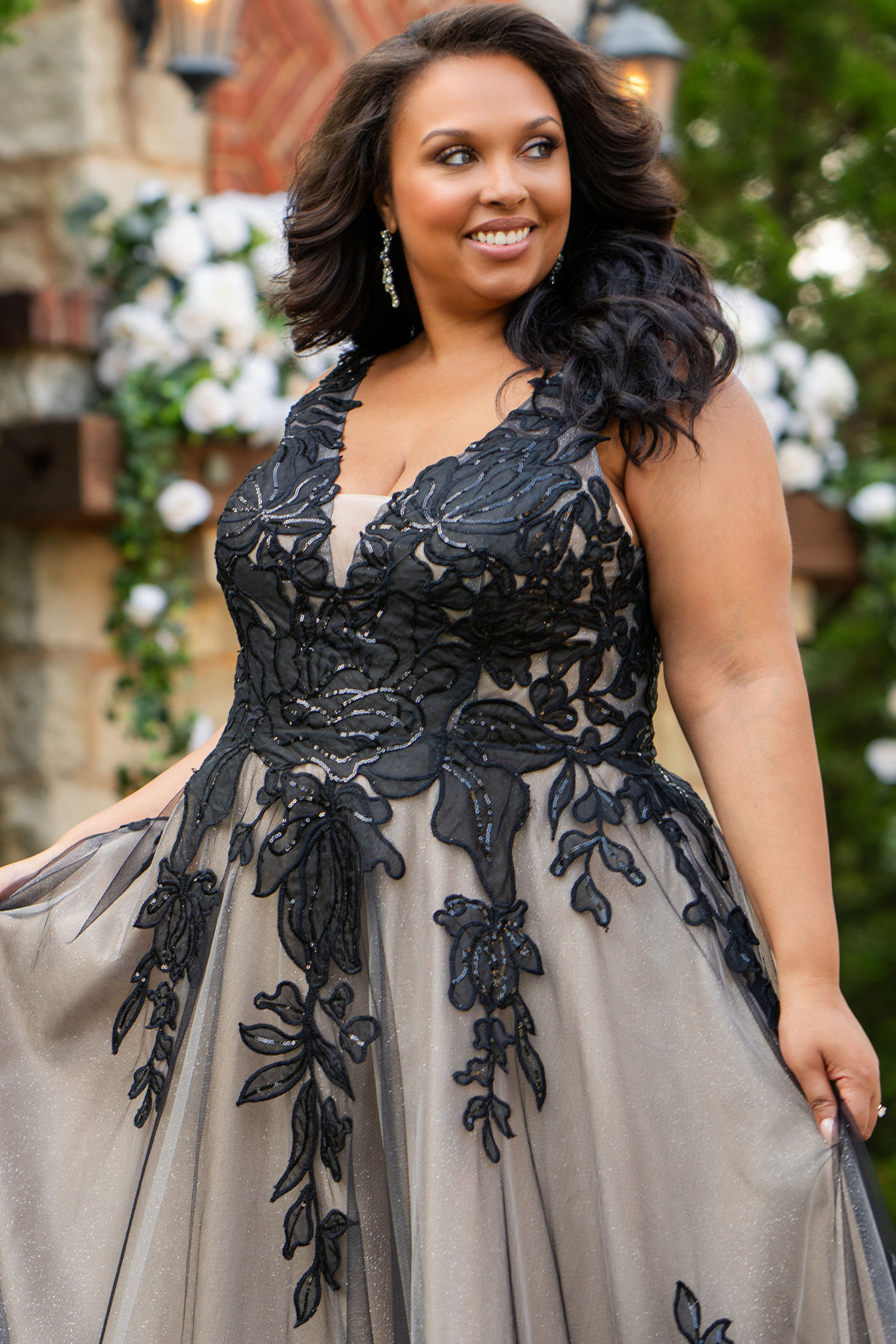 Plus size A-line oversized floral weding dress in black, ivory or champagne. Style MB2525 from Michelle Bridal by Sydney's Closet has illusions straps covered in appliques, natural waisltine, long flowy A-line skirt and long train with covered buttons. 