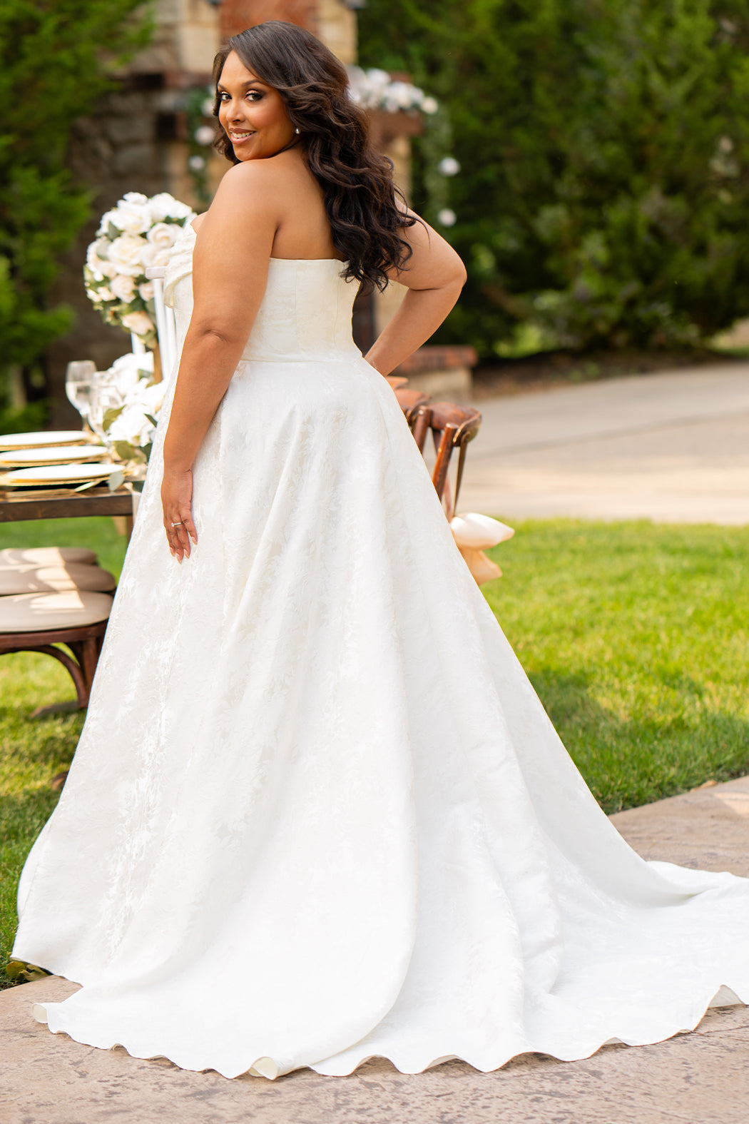 Michelle Bridal MB2601 in Buttercream. Soft brocade fabric, strapless bodice with pleated drape detail, natural waistline and A-line skirt. Pockets and center back zipper. 