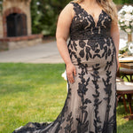 Michelle Bridal MB2606 in black/champagne. Fitted gown with bra-friendly straps, natural waistline, v-neckline, scoop lace back and center back zipper. Black Soft tulle, floral organza appliques over a champagne stretch knit lining. Train.