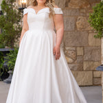Michelle Bridal MB2610 shown in ivory. Off-the-shoulder satin A-line gown, bodice cuff covered in pearls and clear beads. Natural waistline, box pleats on skirt and center back zipper. Long satin train. 
