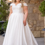 Michelle Bridal MB2610 shown in ivory. Off-the-shoulder satin A-line gown, bodice cuff covered in pearls and clear beads. Natural waistline, box pleats on skirt and center back zipper. Long satin train. 