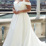 Michelle Bridal MB2610 shown in ivory. Off-the-shoulder satin A-line gown, bodice cuff covered in pearls and clear beads. Natural waistline, box pleats on skirt and center back zipper. Long satin train. 