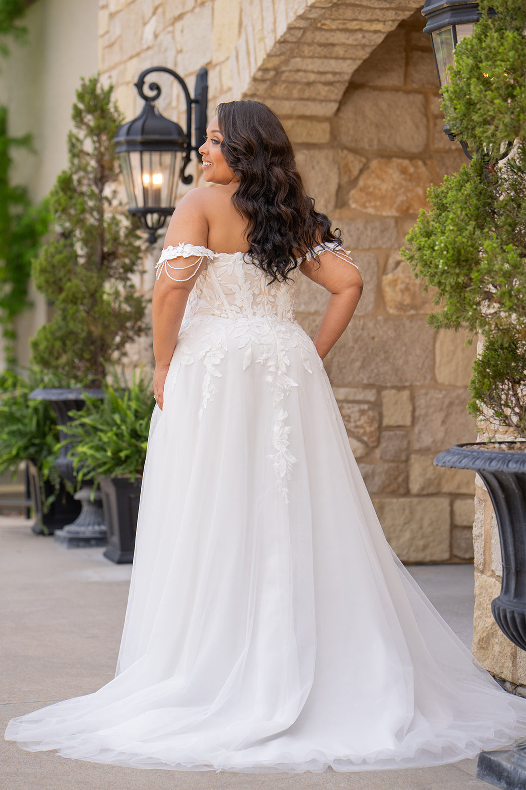 Michelle Bridal MB2611 shown in Ivory/Nude. 
Strapless bodice with deep v-neckline, exposed boning and optional drape straps with beaded detail. Soft bridal tulle A-line skirt with floral appliques, center back zipper. 