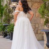 Michelle Bridal MB2611 shown in Ivory/Nude. 
Strapless bodice with deep v-neckline, exposed boning and optional drape straps with beaded detail. Soft bridal tulle A-line skirt with floral appliques, center back zipper. 