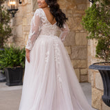 Michelle Bridal MB2612 shown in Ivory/Rosewater. 

Long sleeve tulle A-line, lace covered bodice, v-neckline and 5 inch waistband. Flowy tulle skirt with slit, satin lining and scattered lace appliques. V-back and center back zipper. 