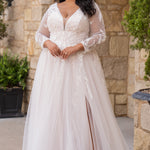 Michelle Bridal MB2612 shown in Ivory/Rosewater. 

Long sleeve tulle A-line, lace covered bodice, v-neckline and 5 inch waistband. Flowy tulle skirt with slit, satin lining and scattered lace appliques. V-back and center back zipper. 