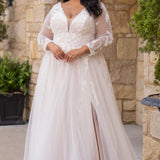 Michelle Bridal MB2612 shown in Ivory/Rosewater. 

Long sleeve tulle A-line, lace covered bodice, v-neckline and 5 inch waistband. Flowy tulle skirt with slit, satin lining and scattered lace appliques. V-back and center back zipper. 