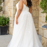 Michelle Bridal MB2613 shown in Ivory. 
Beaded double spaghetti straps, v-neckline, natural waistline. 3D floral appliques, soft bridal tulle, satin lining. A-Line skirt with left leg slit. Scoop back and center back zipper. 