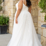 Michelle Bridal MB2613 shown in Ivory. 
Beaded double spaghetti straps, v-neckline, natural waistline. 3D floral appliques, soft bridal tulle, satin lining. A-Line skirt with left leg slit. Scoop back and center back zipper. 