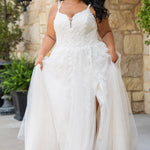 Michelle Bridal MB2613 shown in Ivory. 
Beaded double spaghetti straps, v-neckline, natural waistline. 3D floral appliques, soft bridal tulle, satin lining. A-Line skirt with left leg slit. Scoop back and center back zipper. 