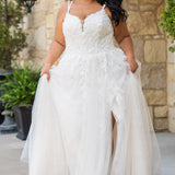 Michelle Bridal MB2613 shown in Ivory. 
Beaded double spaghetti straps, v-neckline, natural waistline. 3D floral appliques, soft bridal tulle, satin lining. A-Line skirt with left leg slit. Scoop back and center back zipper. 